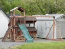 Busy Base Camp Play Set in Woodgrain Brown Vinyl with Green Slides and Swings